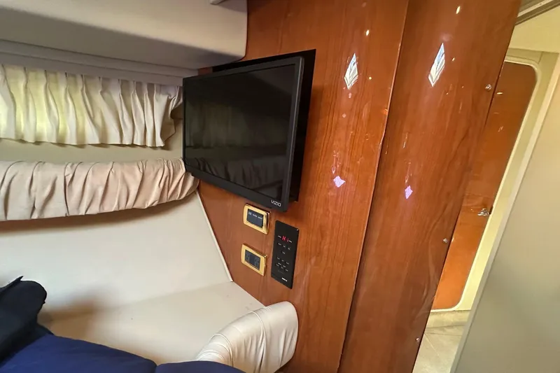 Slide: The Image of Interior of 2001 Sea Ray 410 Sundancer with TV and wood paneling. - 15