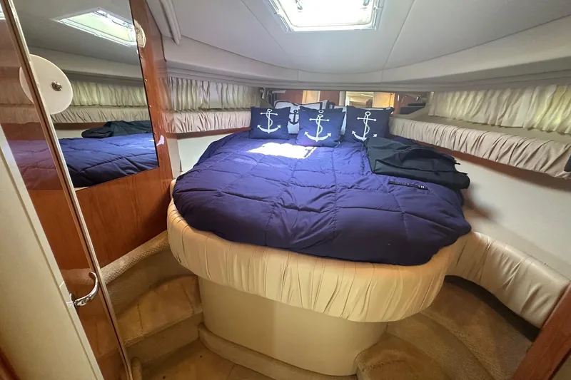 Slide: The Image of Luxurious cabin interior of 2001 Sea Ray 410 Sundancer with nautical-themed bedding. - 17