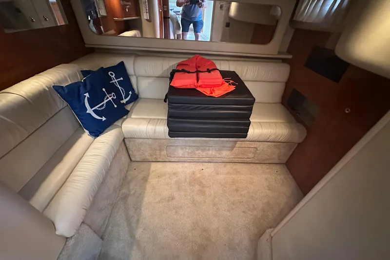 Slide: The Image of Interior of 2001 Sea Ray 410 Sundancer with white seating and nautical-themed decor. - 22