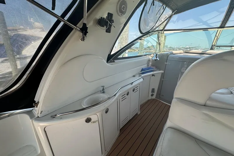 Slide: The Image of Interior of 2001 Sea Ray 410 Sundancer yacht with sleek design and wooden flooring. - 4