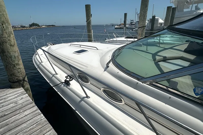 Slide: The Image of 2001 Sea Ray 410 Sundancer yacht docked at a marina on a sunny day. - 1