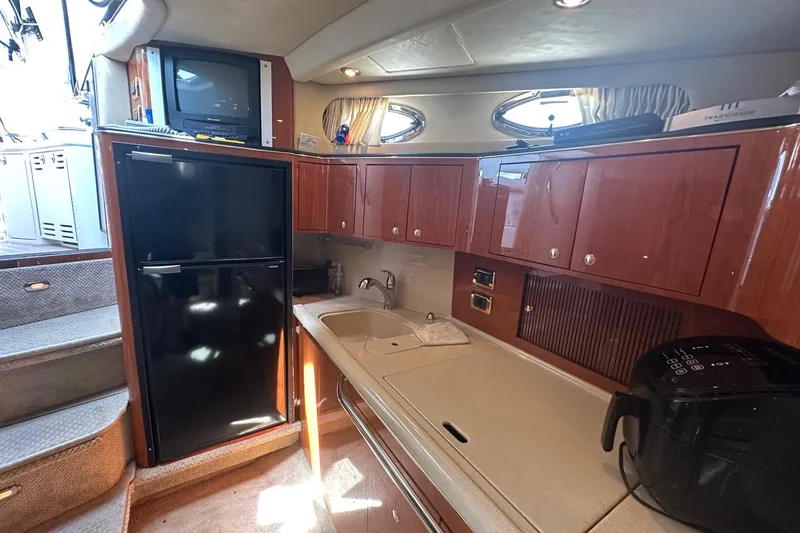 Slide: The Image of Interior of 2001 Sea Ray 410 Sundancer yacht with kitchenette and appliances. - 8