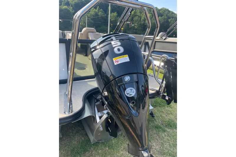 Slide: The Image of Alera A22 2026 boat with a 50 HP outboard motor on grassy area. - 2