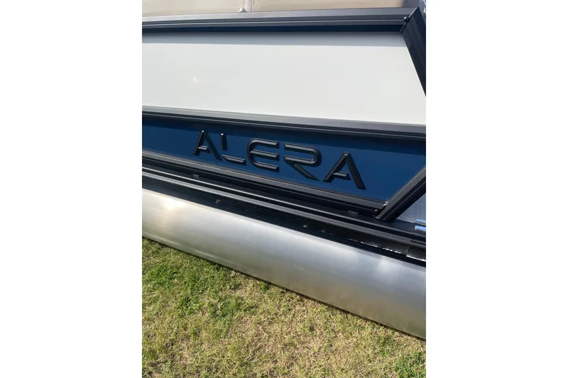 Slide: The Image of 2026 Alera A22 boat side view with logo, displayed on grass. - 6