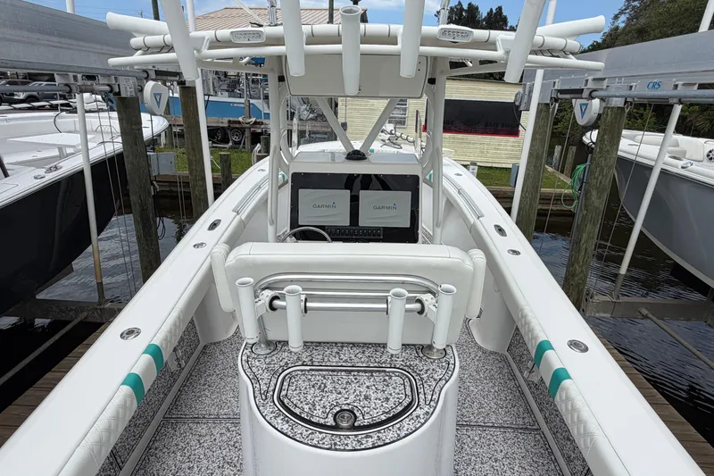 Slide: The Image of 2002 Yellowfin 31 Center Console boat with Garmin navigation, docked at marina. - 12