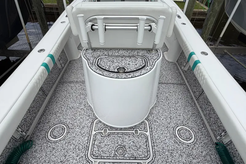Slide: The Image of 2002 Yellowfin 31 Center Console boat interior with rod holders and textured flooring. - 11