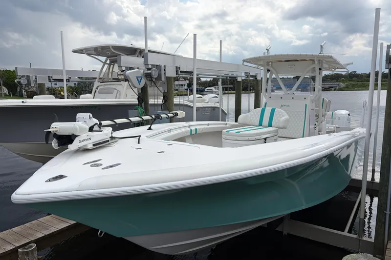 Slide: The Image of 2002 Yellowfin 31 Center Console boat docked, featuring sleek design and Garmin equipment. - 10