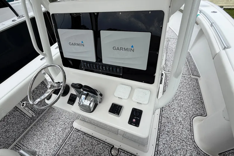 Slide: The Image of 2002 Yellowfin 31 Center Console helm with Garmin displays and steering wheel. - 20
