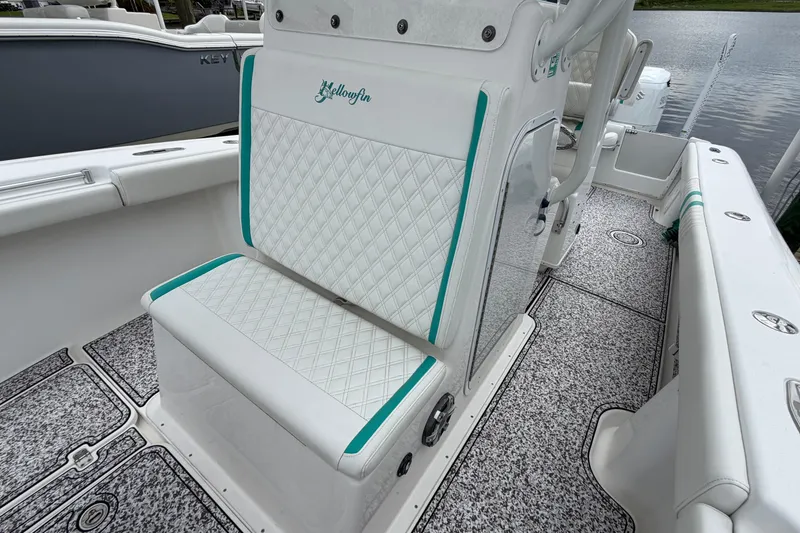 Slide: The Image of 2002 Yellowfin 31 Center Console boat with white and teal seating, diamond pattern upholstery. - 29