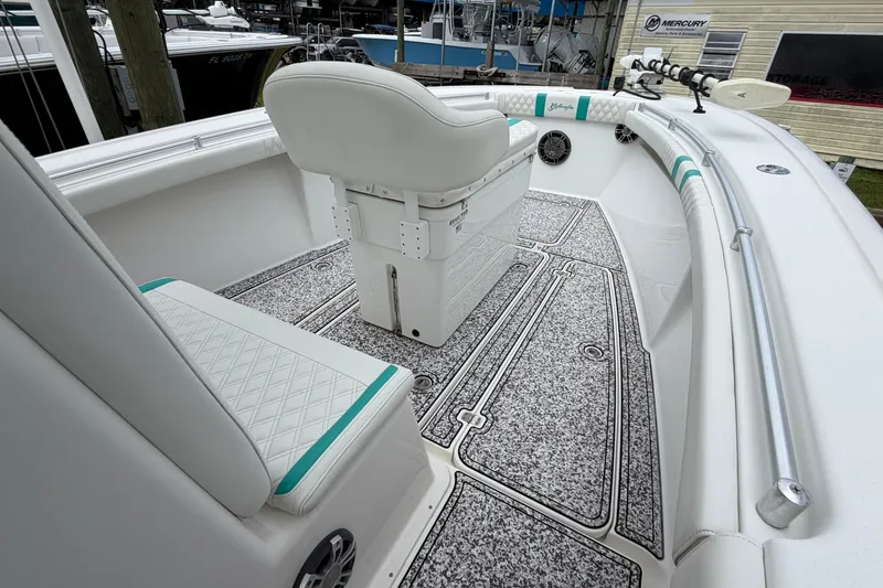 Slide: The Image of 2002 Yellowfin 31 Center Console boat interior with white seating and textured flooring. - 26