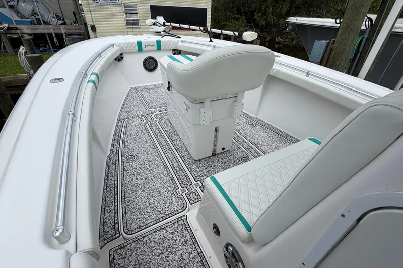 Slide: The Image of 2002 Yellowfin 31 Center Console boat interior with white seating and patterned flooring. - 27