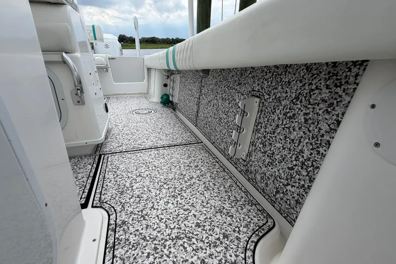 Slide: The Image of 2002 Yellowfin 31 Center Console boat interior with speckled flooring and white seating. - 32