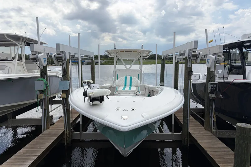 Slide: The Image of 2002 Yellowfin 31 Center Console boat docked at marina under cloudy sky. - 9