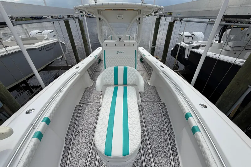 Slide: The Image of 2002 Yellowfin 31 Center Console boat with teal accents docked at marina. - 40