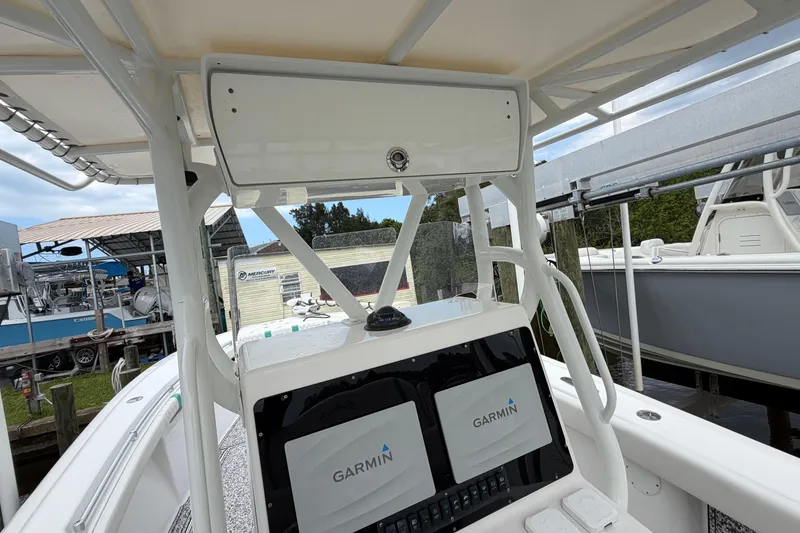 Slide: The Image of 2002 Yellowfin 31 Center Console boat with Garmin navigation system at dock. - 22