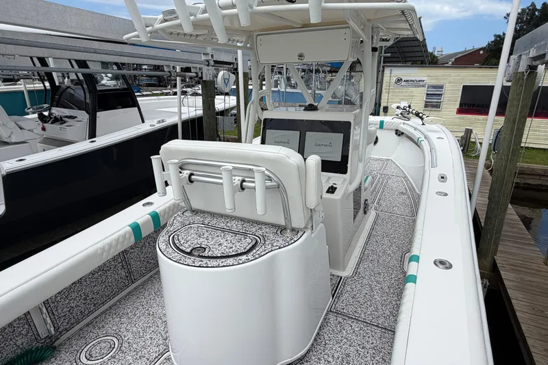 Slide: The Image of 2002 Yellowfin 31 Center Console boat with dual Garmin displays, docked at a marina. - 15