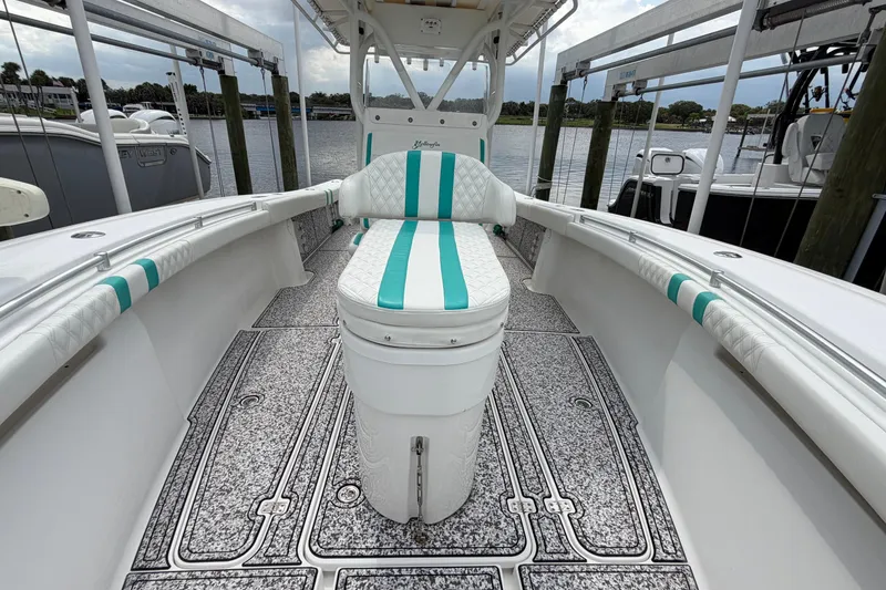 Slide: The Image of 2002 Yellowfin 31 Center Console boat with teal accents and spacious deck. - 37
