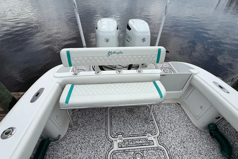 Slide: The Image of 2002 Yellowfin 31 Center Console boat with dual engines and cushioned seating. - 19
