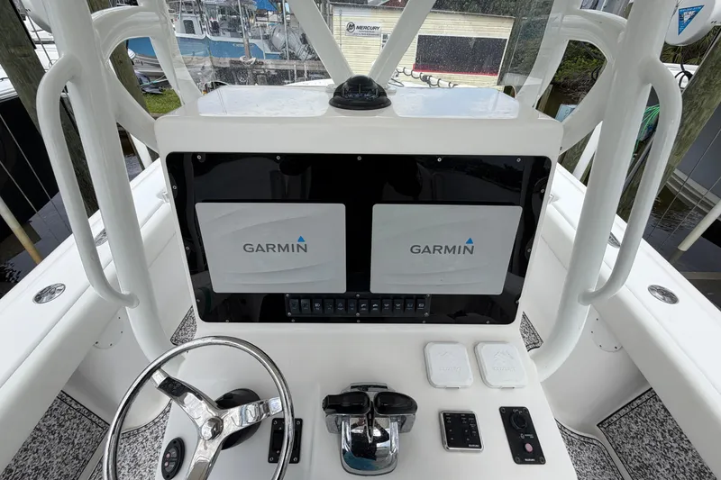 Slide: The Image of 2002 Yellowfin 31 Center Console helm with Garmin navigation displays. - 43