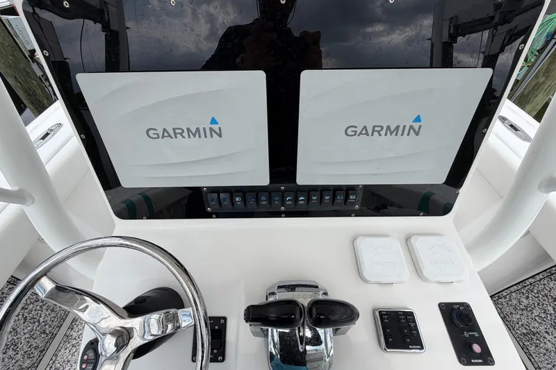 Slide: The Image of Console of 2002 Yellowfin 31 Center Console with Garmin displays and steering wheel. - 42