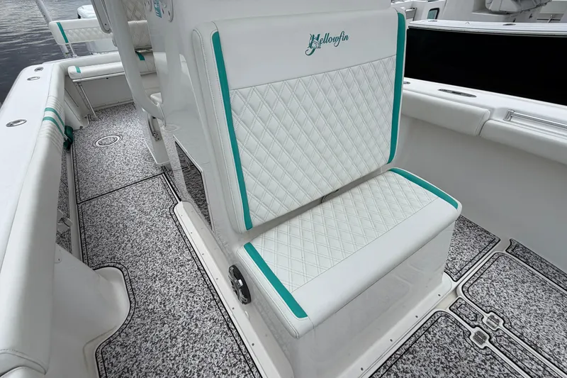Slide: The Image of 2002 Yellowfin 31 Center Console boat interior with diamond-stitched seating and custom flooring. - 30
