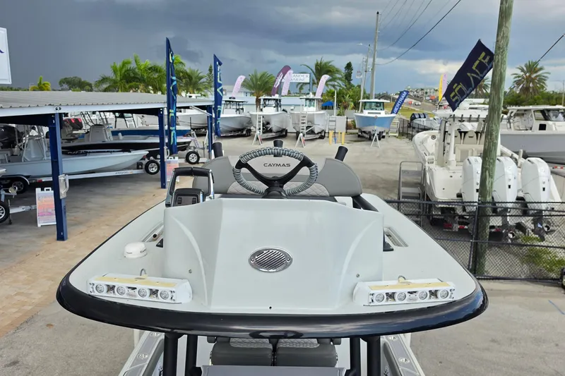 Slide: The Image of 2025 Caymas 281 HB boat displayed at a marina with stormy skies. - 18