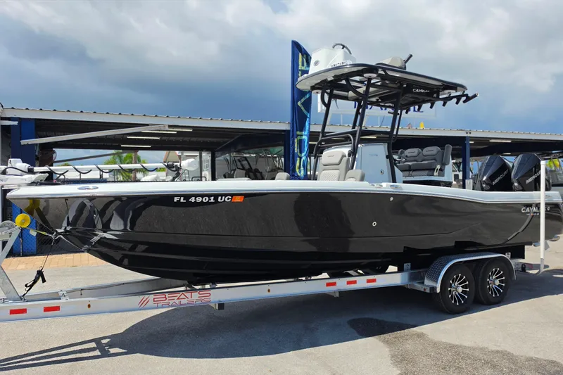 The Image of 2025 Caymas 281 HB boat on trailer, displayed outdoors under cloudy sky. - 1
