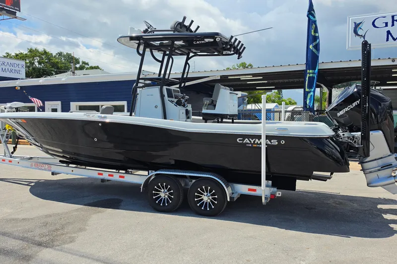 Slide: The Image of 2025 Caymas 281 HB boat on trailer, displayed outdoors at Grander Marine dealership. - 3