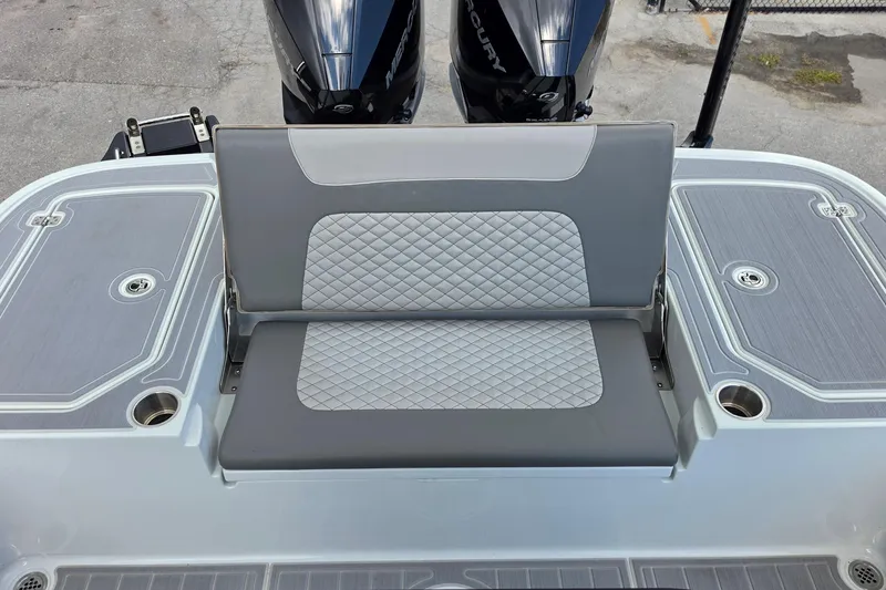 Slide: The Image of 2025 Caymas 281 HB boat with dual Mercury engines and cushioned seating. - 14