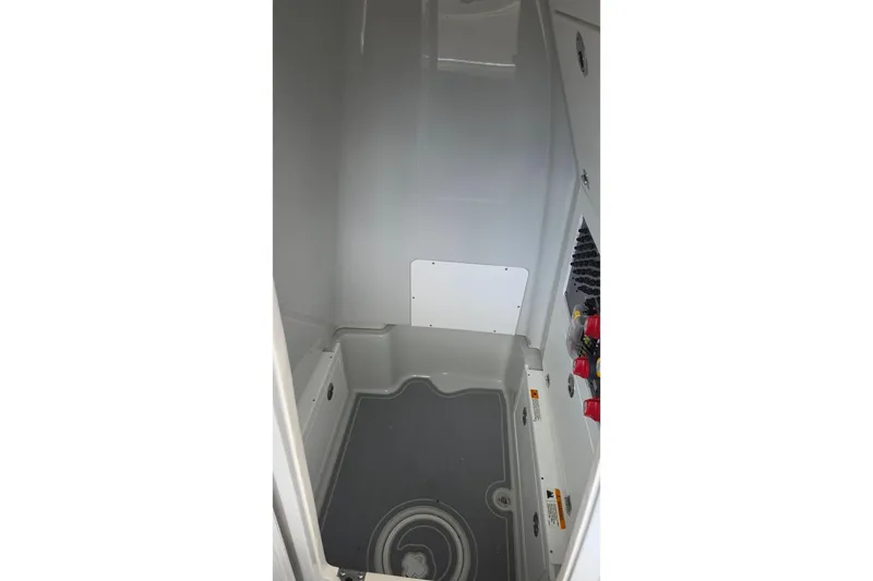 Slide: The Image of Interior view of 2025 Caymas 281 HB boat compartment, featuring storage and utility access. - 20