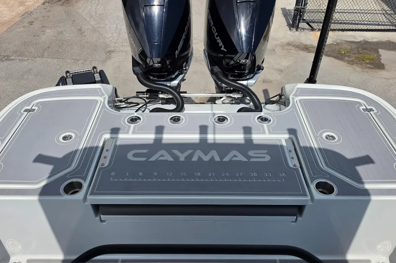 Slide: The Image of 2025 Caymas 281 HB boat deck with dual Mercury engines, featuring sleek design and measurement markings. - 13