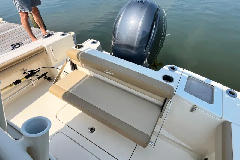Slide: The Image of 2021 Scout 215 XSF boat with Yamaha engine, featuring a foldable rear seat and fishing rod holders. - 12