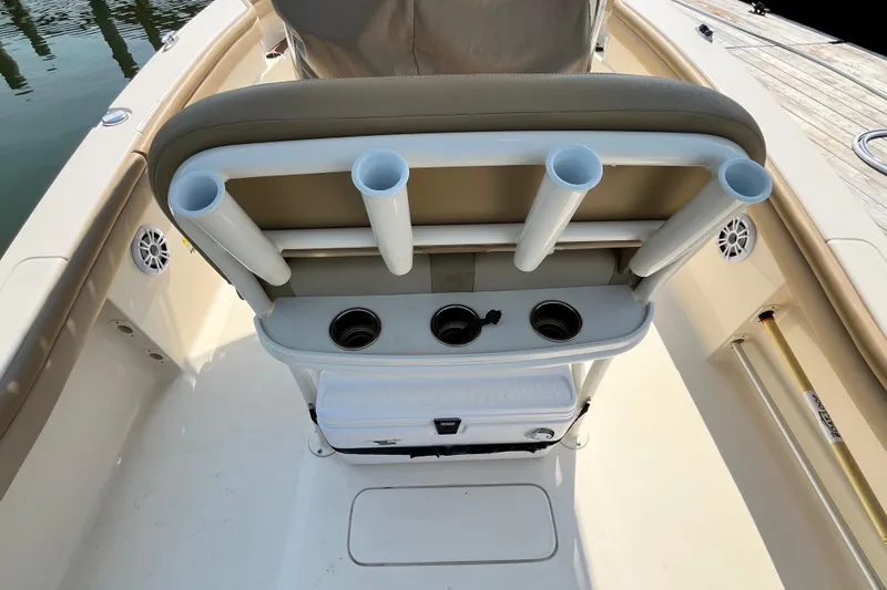 Slide: The Image of 2021 Scout 215 XSF boat interior with rod holders and storage compartment. - 13