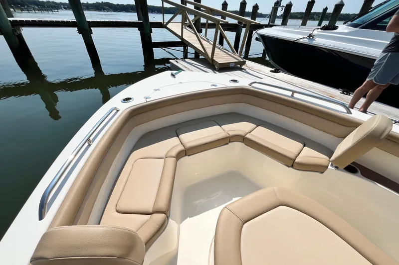 Slide: The Image of 2021 Scout 215 XSF boat with beige seating, docked by the water. - 23