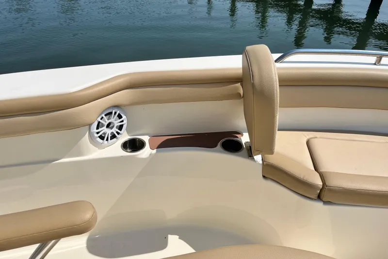 Slide: The Image of 2021 Scout 215 XSF boat interior with beige seating and speaker detail. - 27