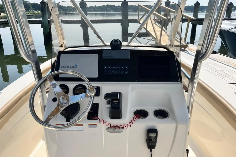 Slide: The Image of 2021 Scout 215 XSF boat dashboard with Garmin navigation system and steering wheel. - 19