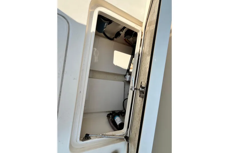 Slide: The Image of Open storage compartment on a 2021 Scout 215 XSF boat. - 28