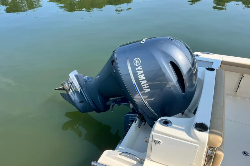 Slide: The Image of 2021 Scout 215 XSF boat with Yamaha outboard motor on calm water. - 10