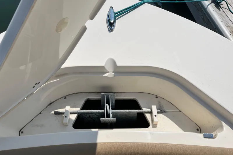 Slide: The Image of Anchor compartment of a 2021 Scout 215 XSF boat, open lid view. - 34