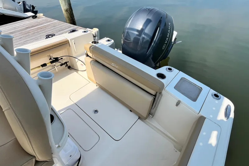Slide: The Image of 2021 Scout 215 XSF boat interior with Yamaha outboard motor at dock. - 11
