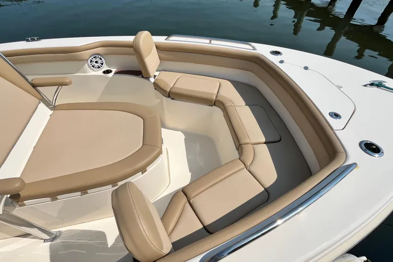 Slide: The Image of 2021 Scout 215 XSF boat with beige seating and stainless steel accents. - 21