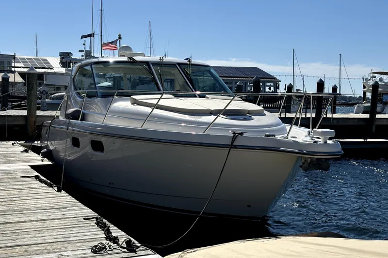 Slide: The Image of 2012 Tiara Yachts 3900 Sovran docked at a marina under clear skies. - 3