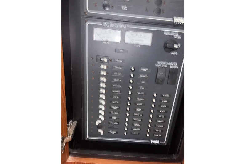 Slide: The Image of Control panel of a 2012 Tiara Yachts 3900 Sovran, featuring DC system switches and gauges. - 48