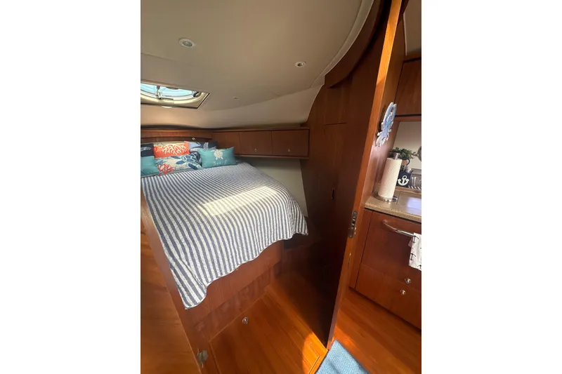 Slide: The Image of Luxurious cabin interior of 2012 Tiara Yachts 3900 Sovran with cozy bedding and wooden finishes. - 36