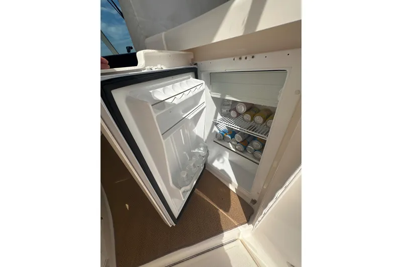 Slide: The Image of Open fridge on 2012 Tiara Yachts 3900 Sovran, stocked with beverages. - 26