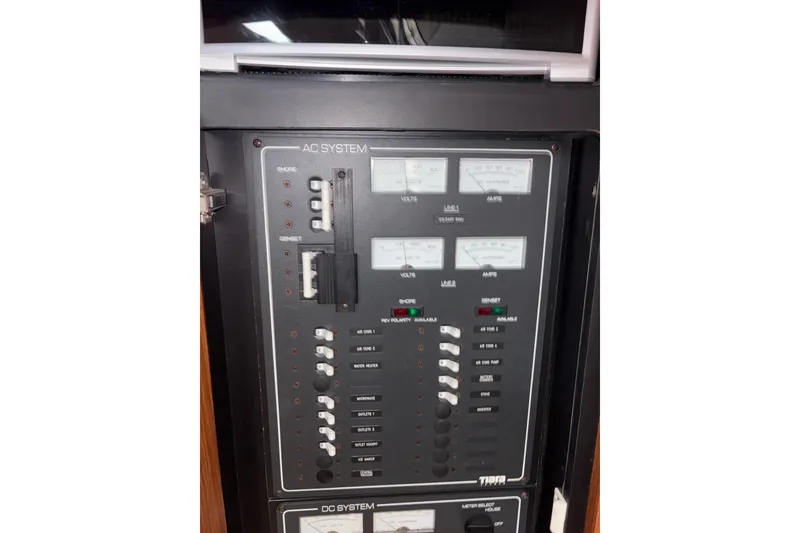 Slide: The Image of Electrical panel of a 2012 Tiara Yachts 3900 Sovran, featuring AC and DC systems. - 47
