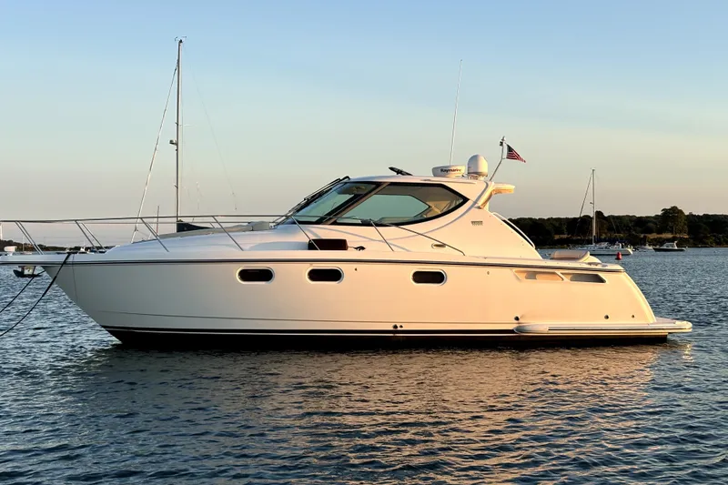 The Image of 2012 Tiara Yachts 3900 Sovran cruising on calm waters at sunset. - 0
