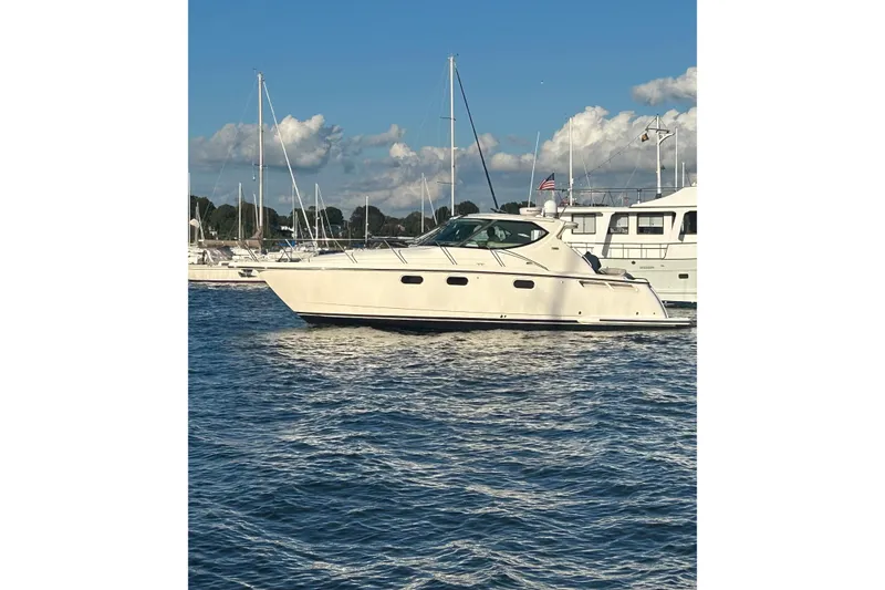 Slide: The Image of 2012 Tiara Yachts 3900 Sovran cruising on a sunny day, surrounded by other boats. - 4