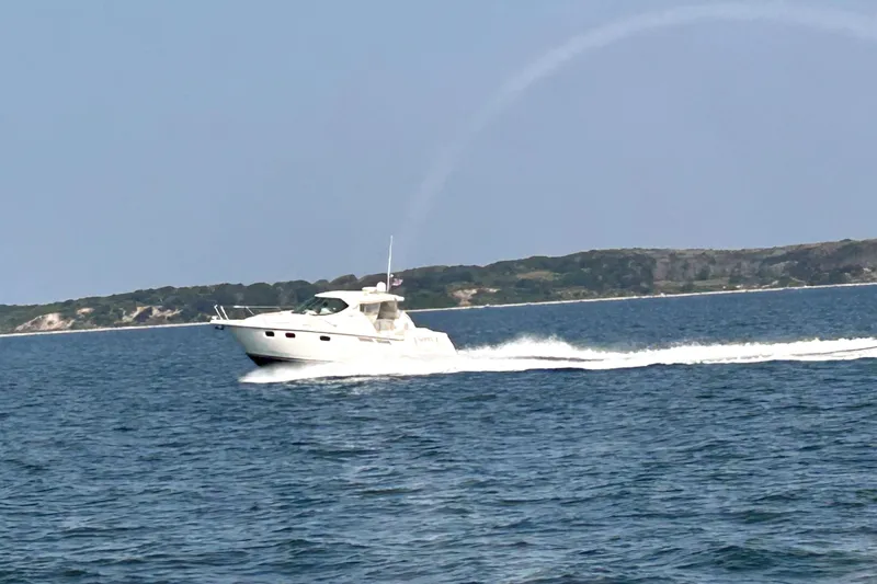 Slide: The Image of 2012 Tiara Yachts 3900 Sovran cruising on open water near a scenic coastline. - 8