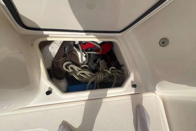 Slide: The Image of Storage compartment on a 2012 Tiara Yachts 3900 Sovran, containing ropes and footwear. - 21
